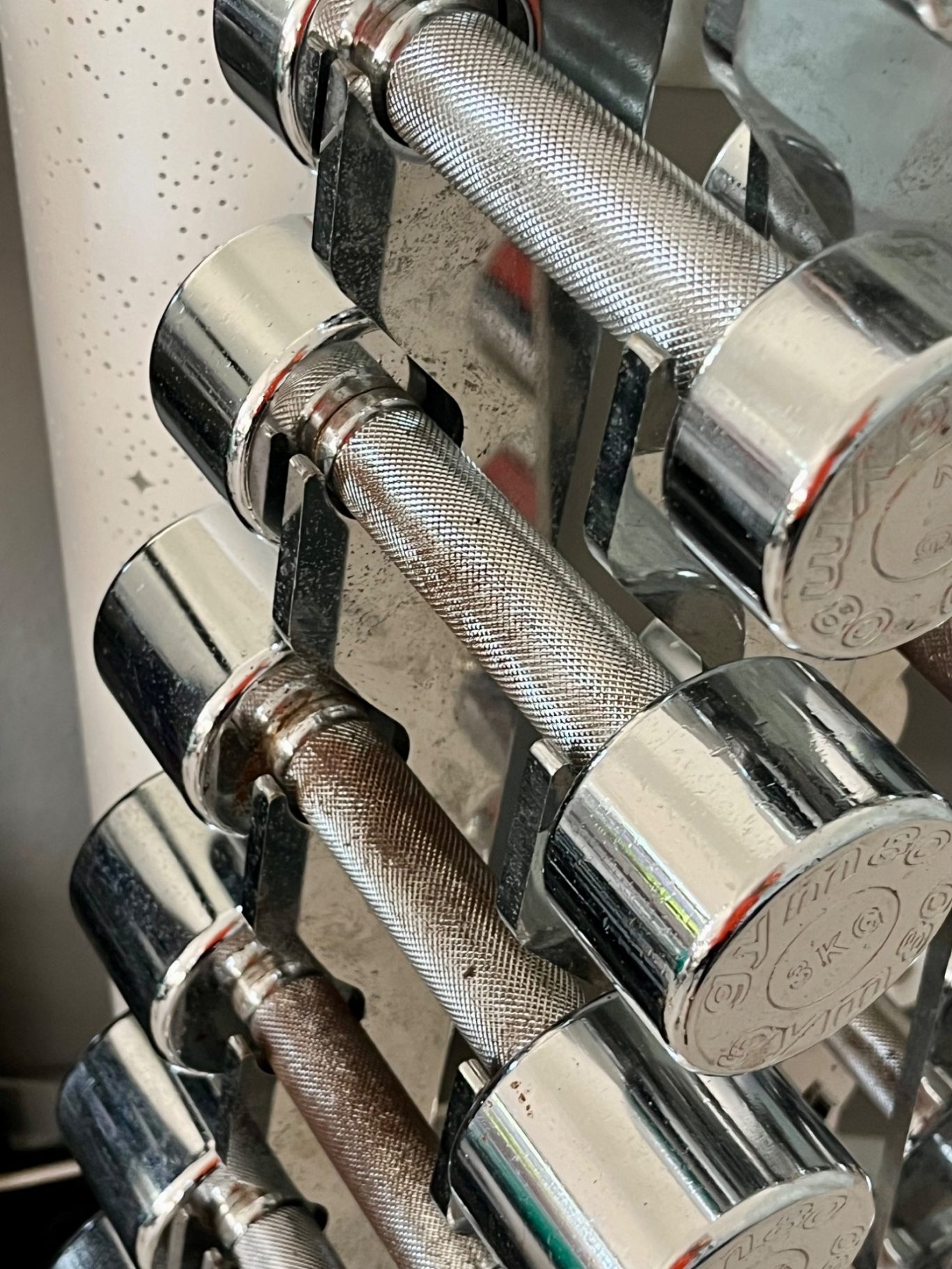 Detailaufnahme silberne kleine Hanteln auf einem Ständer